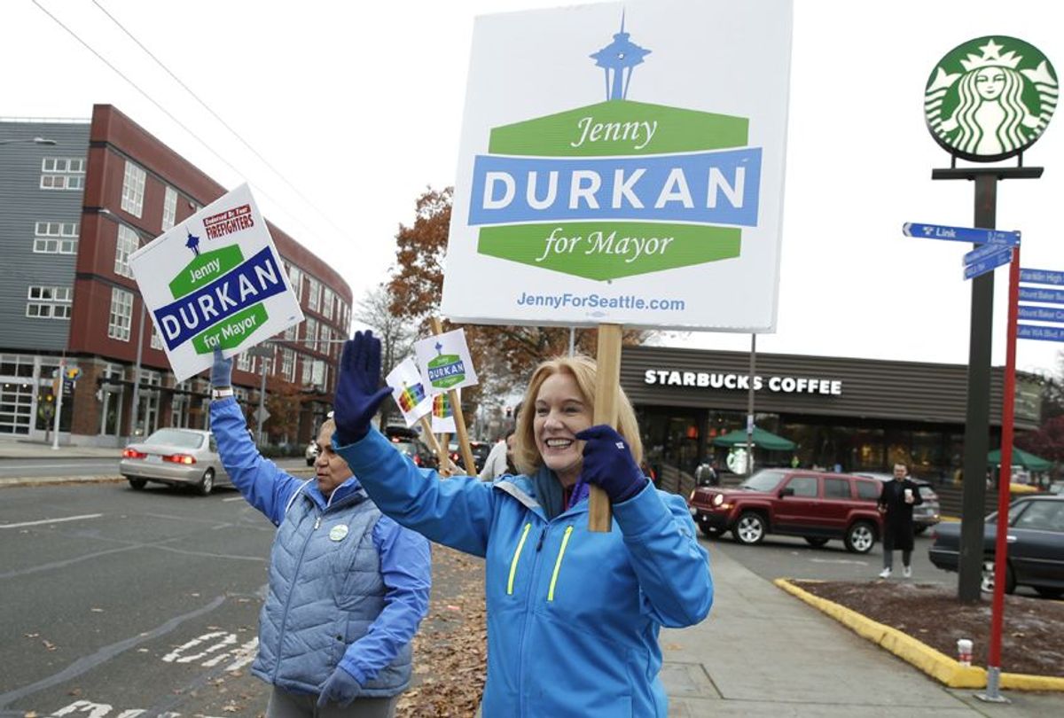 Jenny Durkan, right, joins supporters waving signs on Election Day, Nov. 7, 2017, in Seattle. (AP/Ted S. Warren)