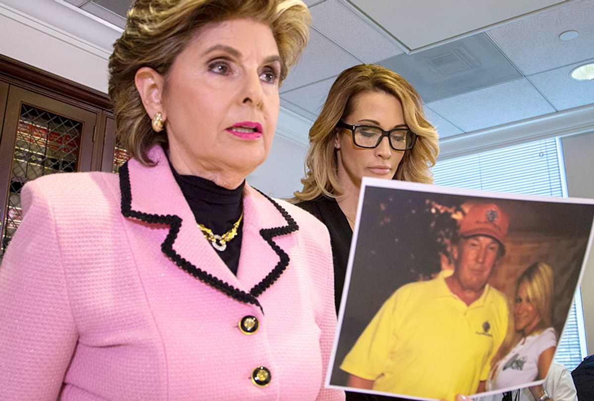 Attorney Gloria Allred holds a photo of jessica drake (R) with Donald Trump, taken in 2006 where Drake alleges Trump behaved in an sexually inappropriate way toward her. (Getty/David McNew)