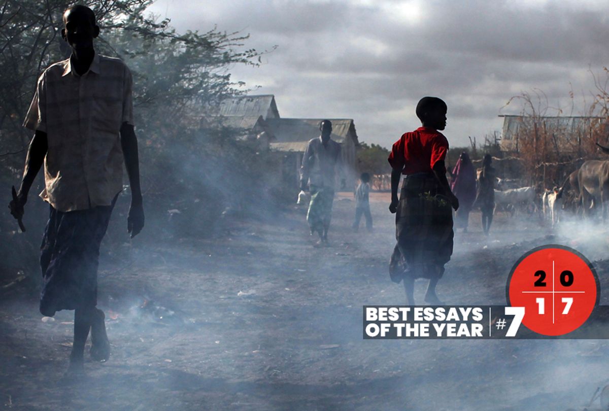 People walk through burning refuse in Dadaab, Kenya the world's biggest refugee complex August 20, 2009 in Dadaab, Kenya (Getty/Spencer Platt)