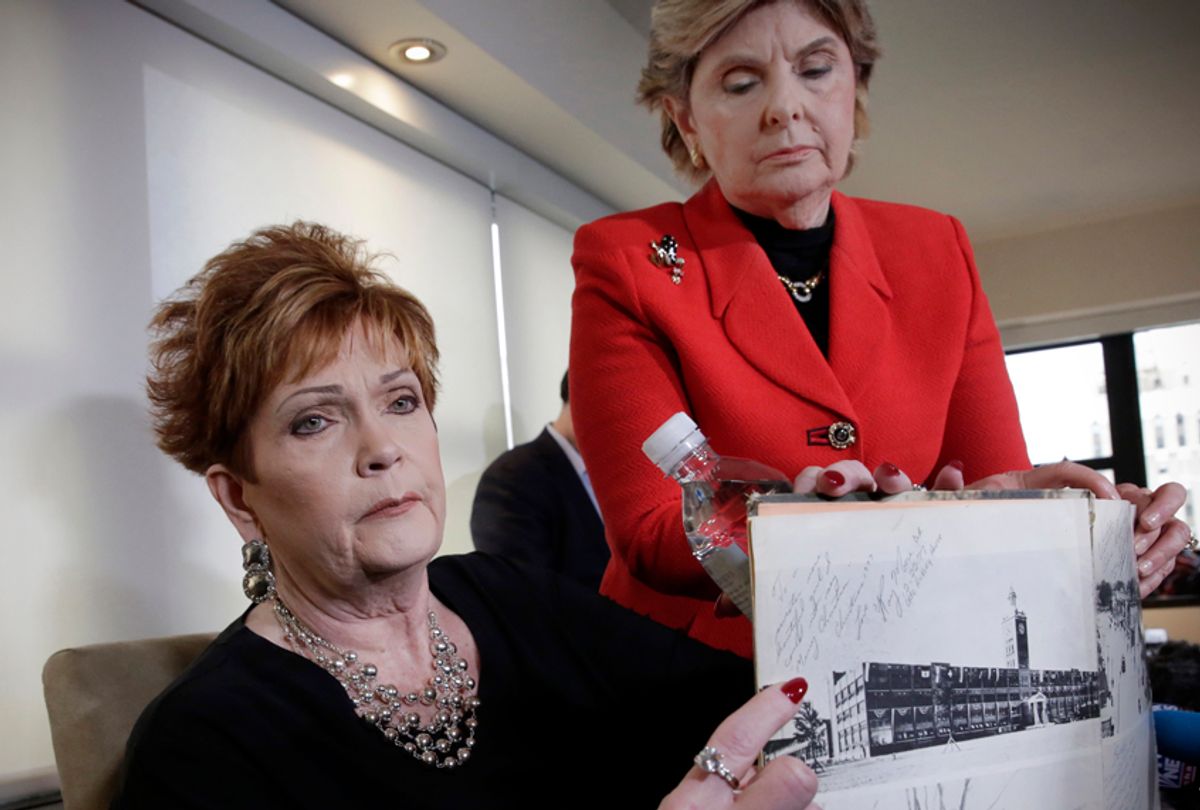 Beverly Young Nelson and attorney Gloria Allred hold Nelson's high school yearbook, signed by Moore, Nov. 13, 2017. (AP/Richard Drew)
