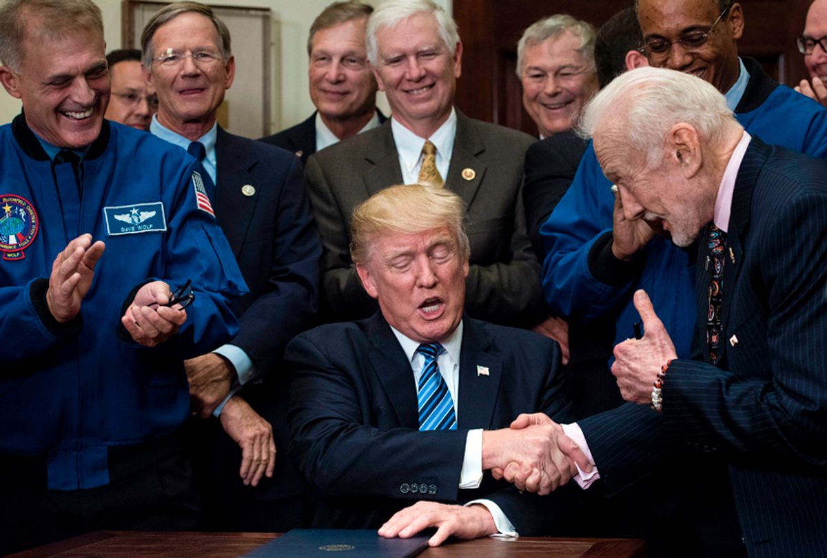 Donald Trump shakes former NASA Astronaut and second man on the moon, Buzz Aldrin's hand after signing an executive order to send American astronauts back to the moon, and eventually Mars. (Getty/Brendan Smialowsk)