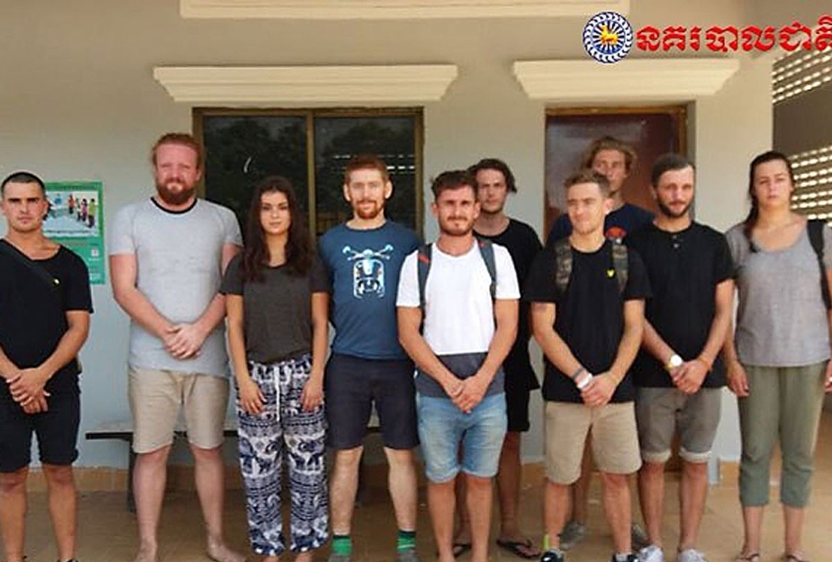 A group of foreigners stand after they were arrested for "dancing pornographically" at a party in Siem Reap town (AP/Cambodian National Police)