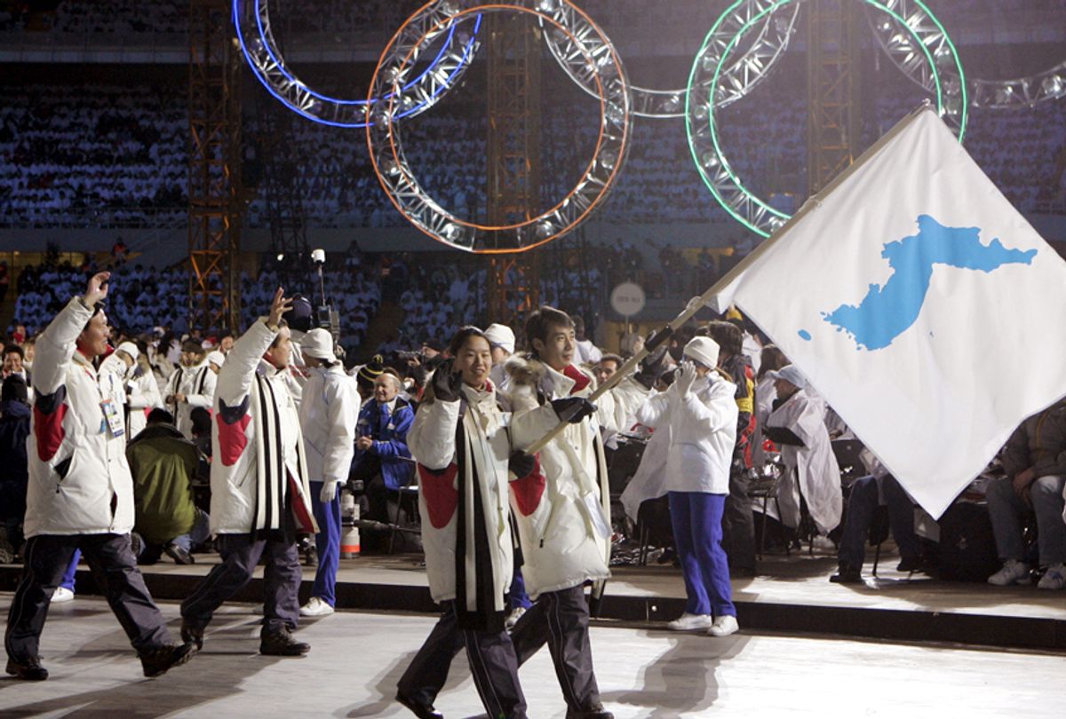 Korea flag-bearer's Bora Lee and Jong-In Lee, carrying a unification flag, lead their teams into the stadium during the 2006 Winter Olympics opening ceremony. (AP/Amy Sancetta)