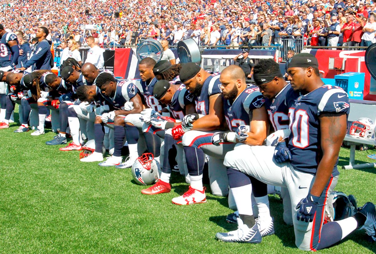 Members of the New England Patriots kneel during the National Anthem before a game (Getty/Jim Rogash)