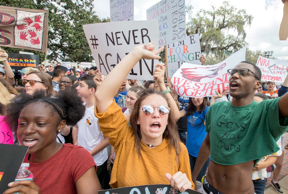 Therese Gachnauer, center, a 18 year old senior from Chiles High School and Kwane Gatlin, right, a 19 year old senior from Lincoln High School, join fellow students protesting gun violence on the steps of the old Florida Capitol in Tallahassee, Fla., Feb. 21, 2018. (AP/Mark Wallheiser)