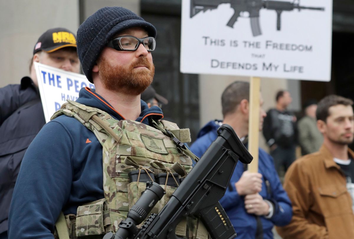 Ben Garrison  wears his Kel-Tec RDB gun, and several magazines of ammunition, during a gun rights rally at the Capitol in Olympia, Wash. (AP/Ted S. Warren)