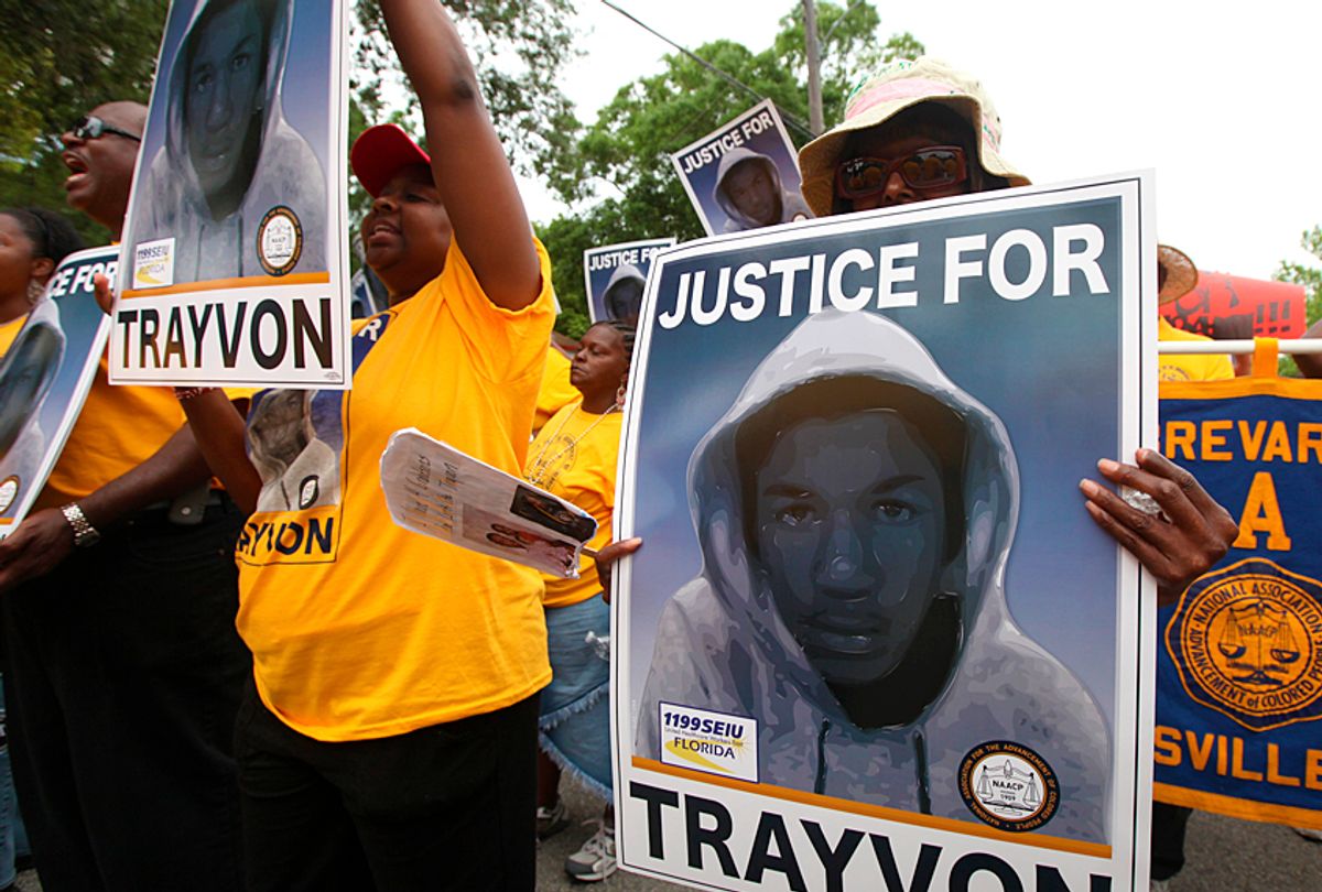 Protestors hold up signs in a march and rally for slain Florida teenager Trayvon Martin (AP/Julie Fletcher)