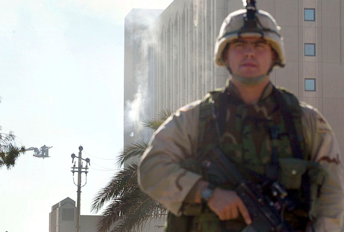 A U.S. Army soldier stands by Iraqi's Oil Ministry after it was hit by missiles, November 21, 2003 in Baghdad, Iraq. (Getty/Joe Raedle)