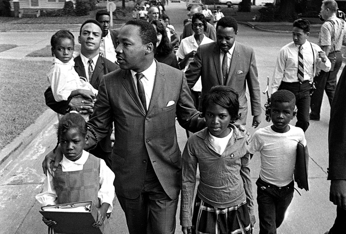 Dr. Martin Luther King Jr. walks between seven-year-old Eva Gracelemon, left, and 10-year-old Aritha Willis as he escorts black school children to formerly all-white schools in Grenada, Miss., Tuesday morning, Sept. 20, 1966.   (AP)