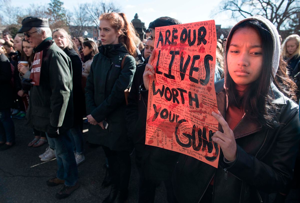 A student holds a sign at Georgetown University on March 14, 2018 during a national walkout to protest gun violence, one month after the school shooting in Parkland, Florida. (Getty Images)
