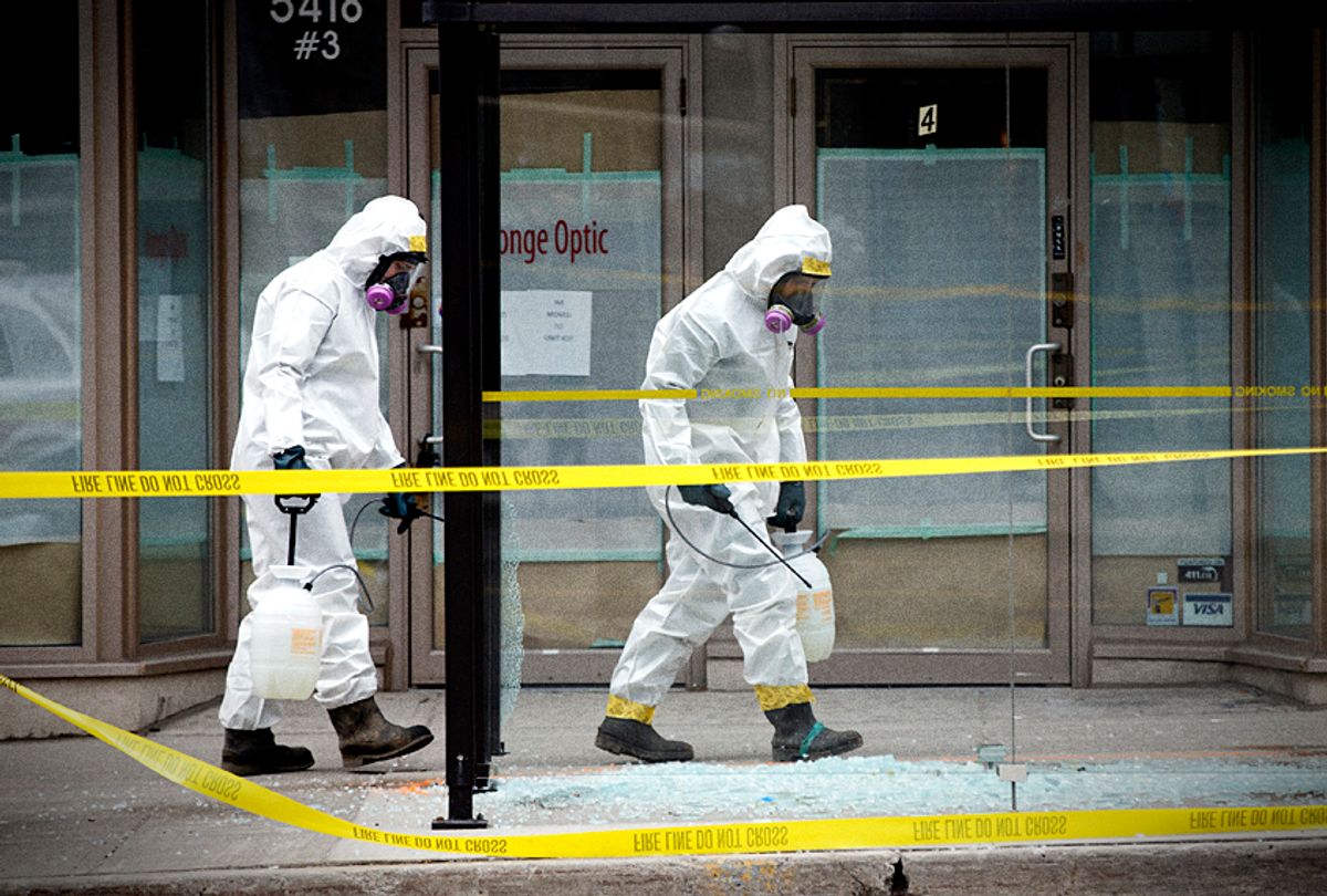 Hazmat workers work around the scene at Yonge St. in Toronto, Canada after a driver in a white rental van collided with multiple pedestrians killing ten and injuring at least 15. (Getty/Cole Burston)