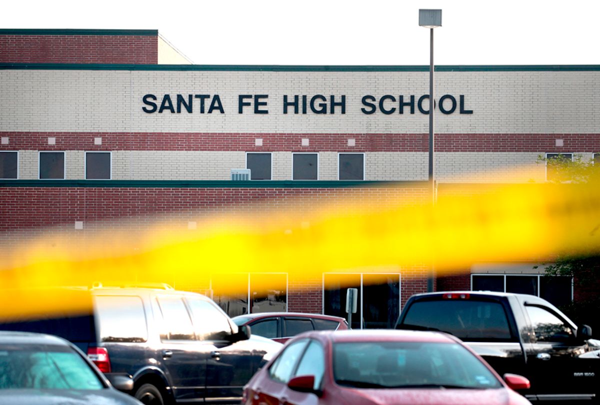 Crime scene tape is stretched across the front of  Santa Fe High School. 17-year-old student Dimitrios Pagourtzis entered the school with a shotgun and a pistol and opened fire, killing at least 10 people. (Getty/Scott Olson)