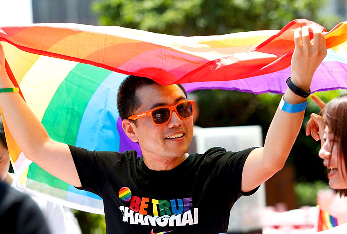A man holds a rainbow flag after taking part in the Pride Run, part of Shanghai's ninth annual gay-pride festival, in Shanghai on June 17, 2017. (Getty/China OUT)