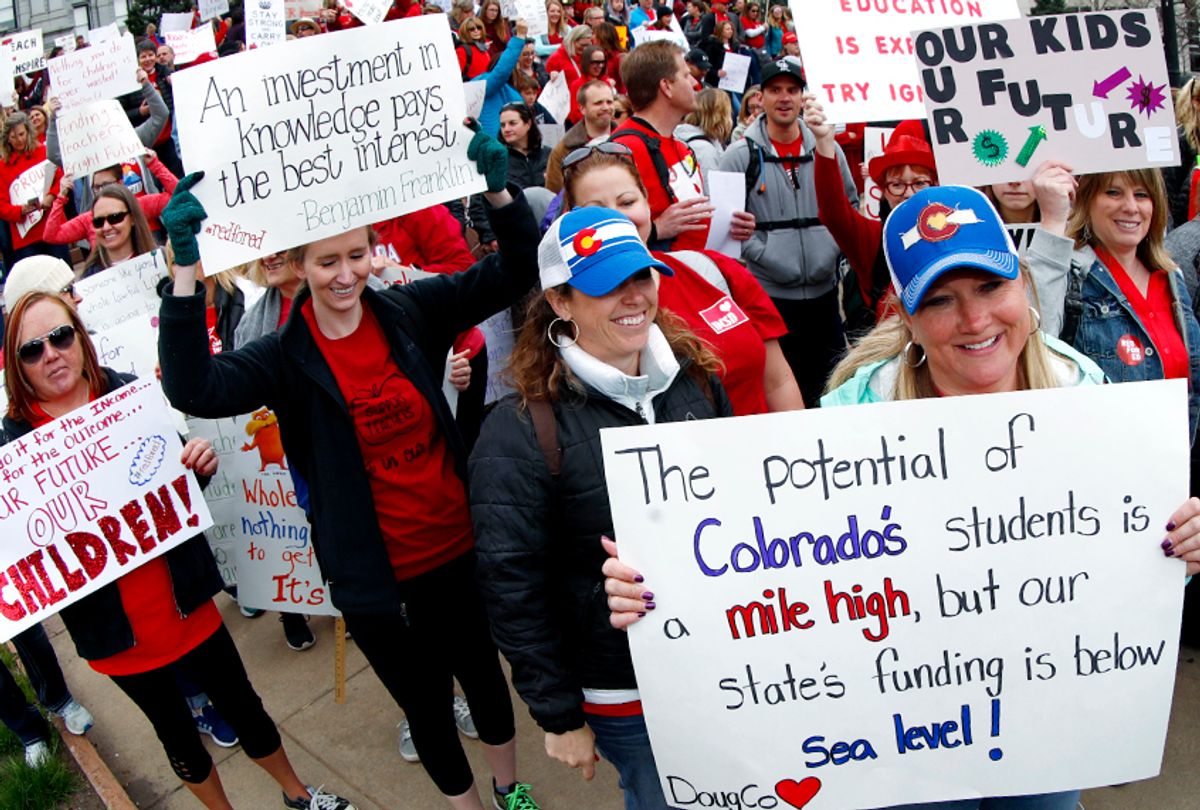 Teachers march around the state Capitol during a teacher rally in Denver.  (AP/David Zalubowski)