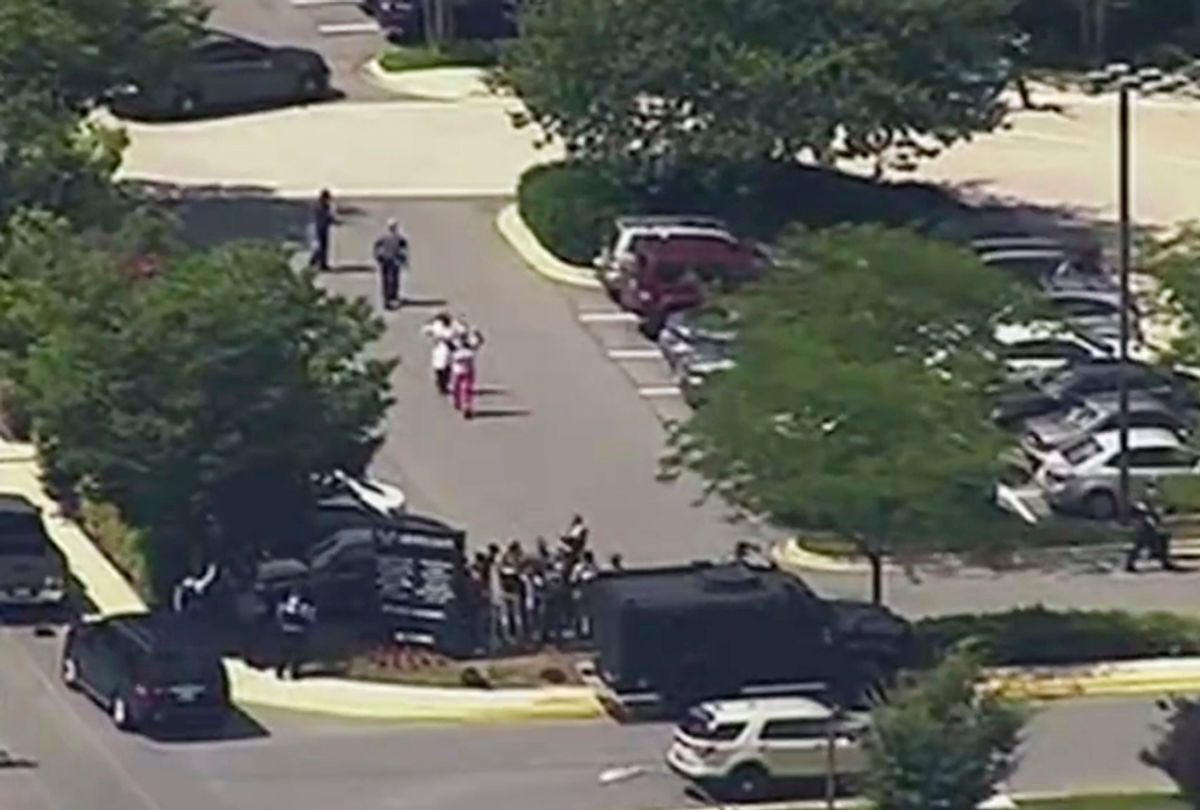 In this frame from video, people leave the Capital Gazette newspaper after multiple people have been shot on Thursday, June 28, 2018, in Annapolis, Md. (WJLA via AP)