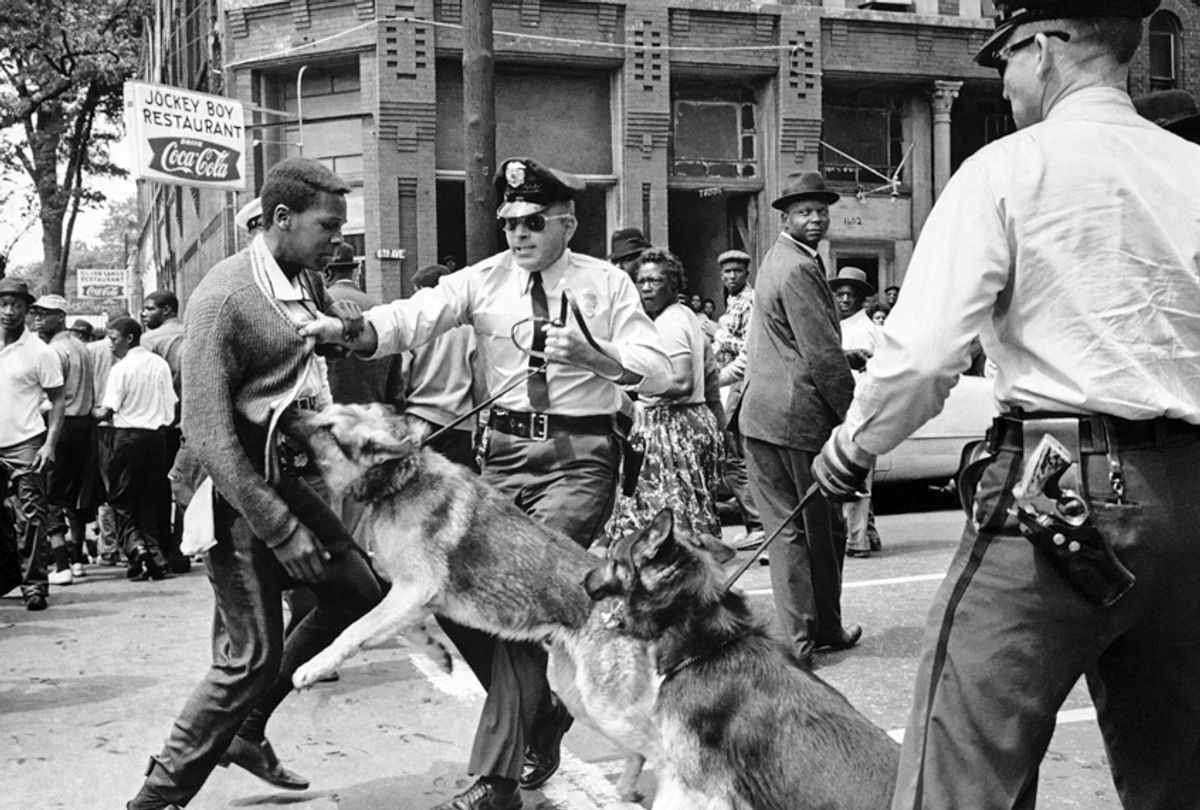 A 17-year-old civil rights demonstrator, defying an anti-parade ordinance of Birmingham, Ala., is attacked by a police dog on May 3, 1963. (AP/Bill Hudson)