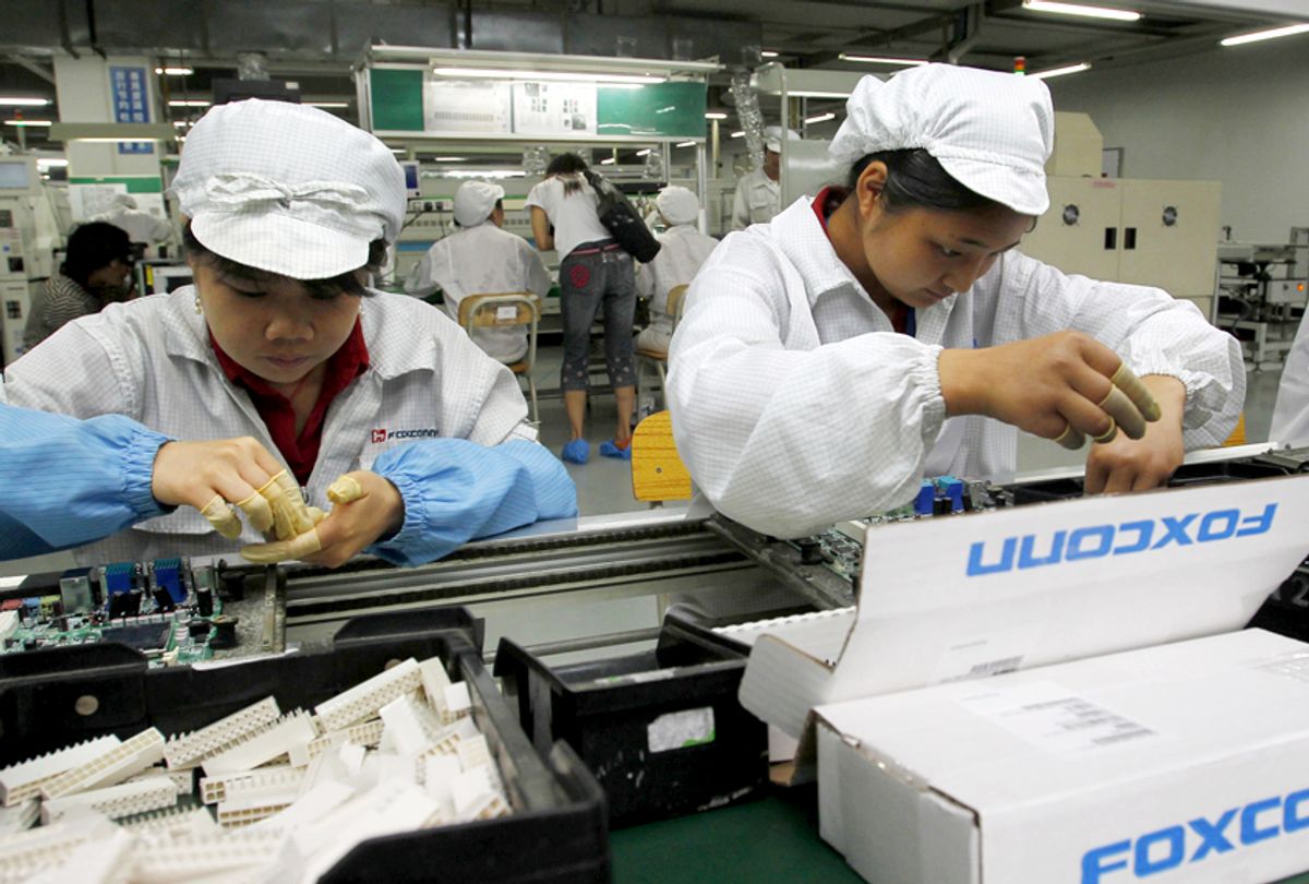 Staff members work on the production line at the Foxconn complex in Shenzhen, China. (AP/Kin Cheung)