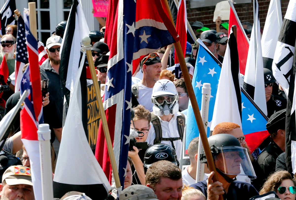 White nationalist demonstrators walk into the entrance of Lee Park surrounded by counter demonstrators in Charlottesville, Va., Saturday, Aug. 12, 2017. (AP/Steve Helber)