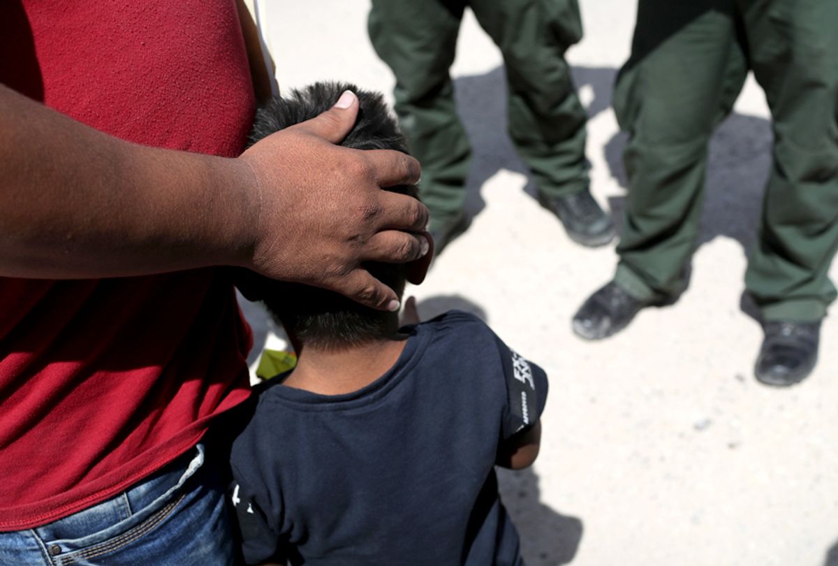 U.S. Border Patrol agents take a father and son from Honduras into custody near the U.S.-Mexico border near Mission, Texas. (Getty/John Moore)