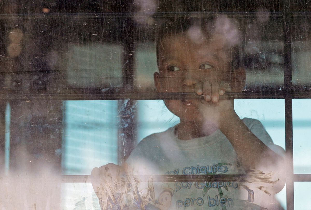 An immigrant child looks out from a U.S. Border Patrol bus, McAllen, Texas, June 23, 2018. (AP/David J. Phillip)