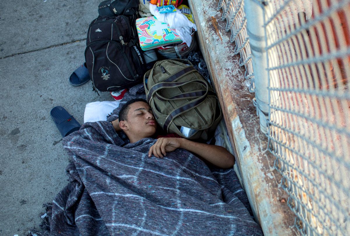 A 14-year-old boy from Honduras sleeps on the Mexican side of the Brownsville & Matamoros International Bridge, where he and his family have been waiting for days after being denied entry into the U.S., near Brownsville, Texas.  (Getty/Tamir Kalifa)