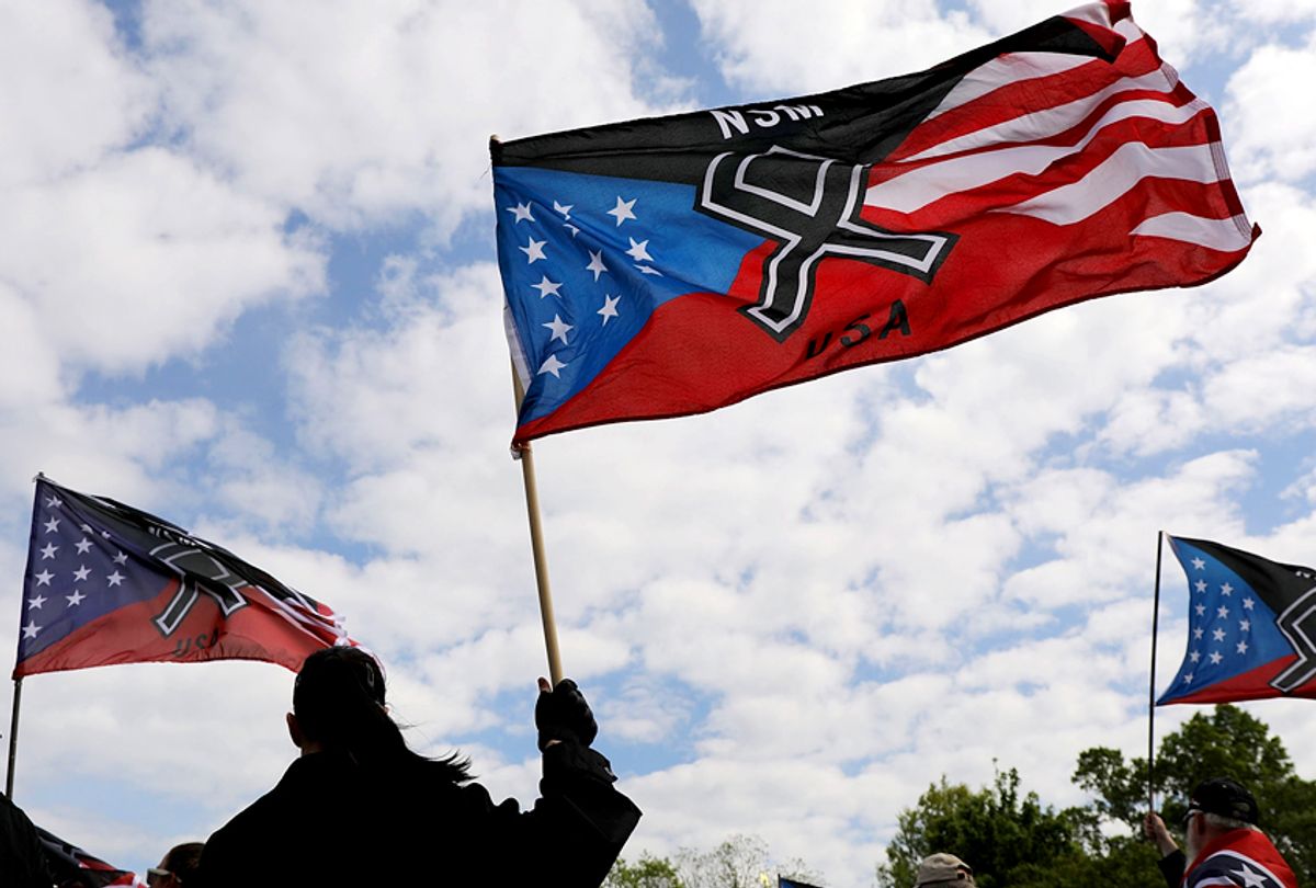 Members and supporters of the National Socialist Movement, one of the largest neo-Nazi groups in the US, hold a rally. (Getty/Spencer Platt)