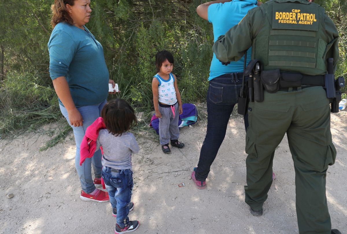 U.S. Border Patrol agents take Central American asylum seekers into custody on June 12, 2018 near McAllen, Texas. The immigrant families were then sent to a U.S. Customs and Border Protection (CBP) processing center for possible separation. (Getty/John Moore)