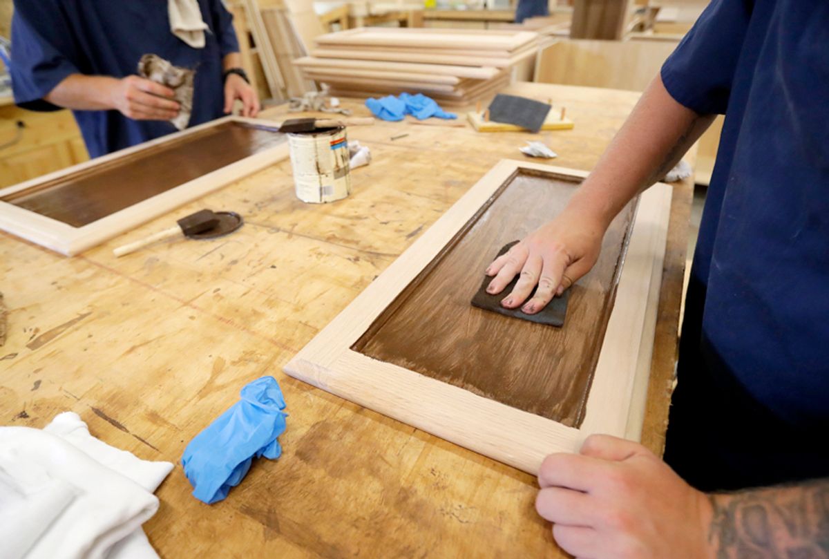 Inmates work on staining cabinet doors at the Habitat for Humanity Prison Build at the Ionia Correctional Facility in Ionia, Mich. (AP/Carlos Osorio)