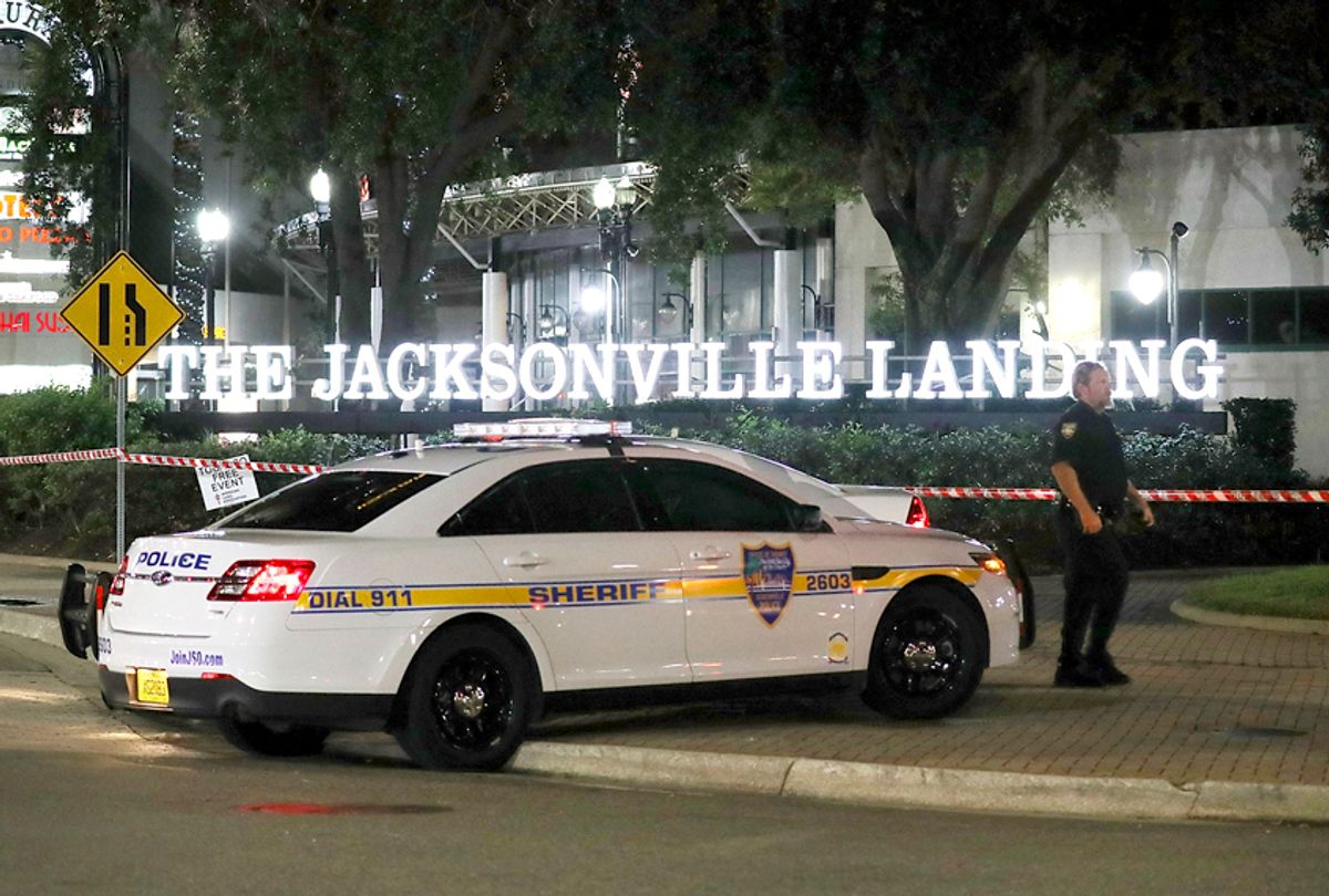 A Jacksonville Sheriff officer helps keep the perimeter secure as law enforcement investigates a shooting at the GLHF Game Bar at the Jacksonville Landing on August 27, 2018 in Jacksonville, Florida. (Getty/Joe Raedle)