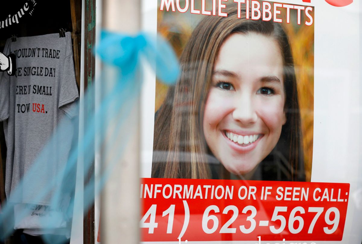 A poster for missing University of Iowa student Mollie Tibbetts hangs in the window of a local business, Aug. 21, 2018, in Brooklyn, Iowa. (AP/Charlie Neibergall)