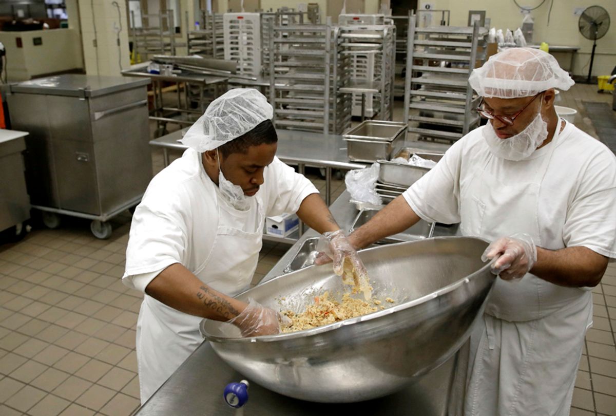 Monroe Laws and Antoine Money mix ingredients to make a nutraloaf, a meal typically given to inmates for misbehavior involving food or bodily waste, before cooking it in a kitchen at James T. Vaughn Correctional Center in Smyrna, Del. (AP/Patrick Semansky)