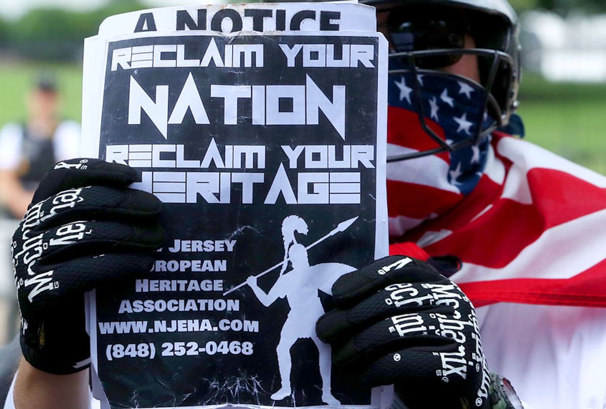 A white supremacist holds up a flyer during the Unite the Right rally in Lafayette Park across from the White House August 12, 2018 in Washington, DC. (Getty/Mark Wilson)
