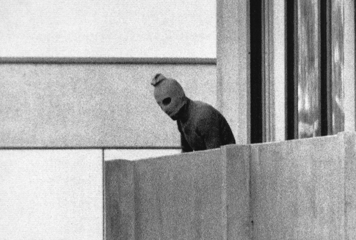 A Palestinian gunman looks from an apartment in which were seized members of the Israeli Olympic Team at the Munich Olympic Village, Sept. 5, 1972. (AP/Kurt Strumpf)
