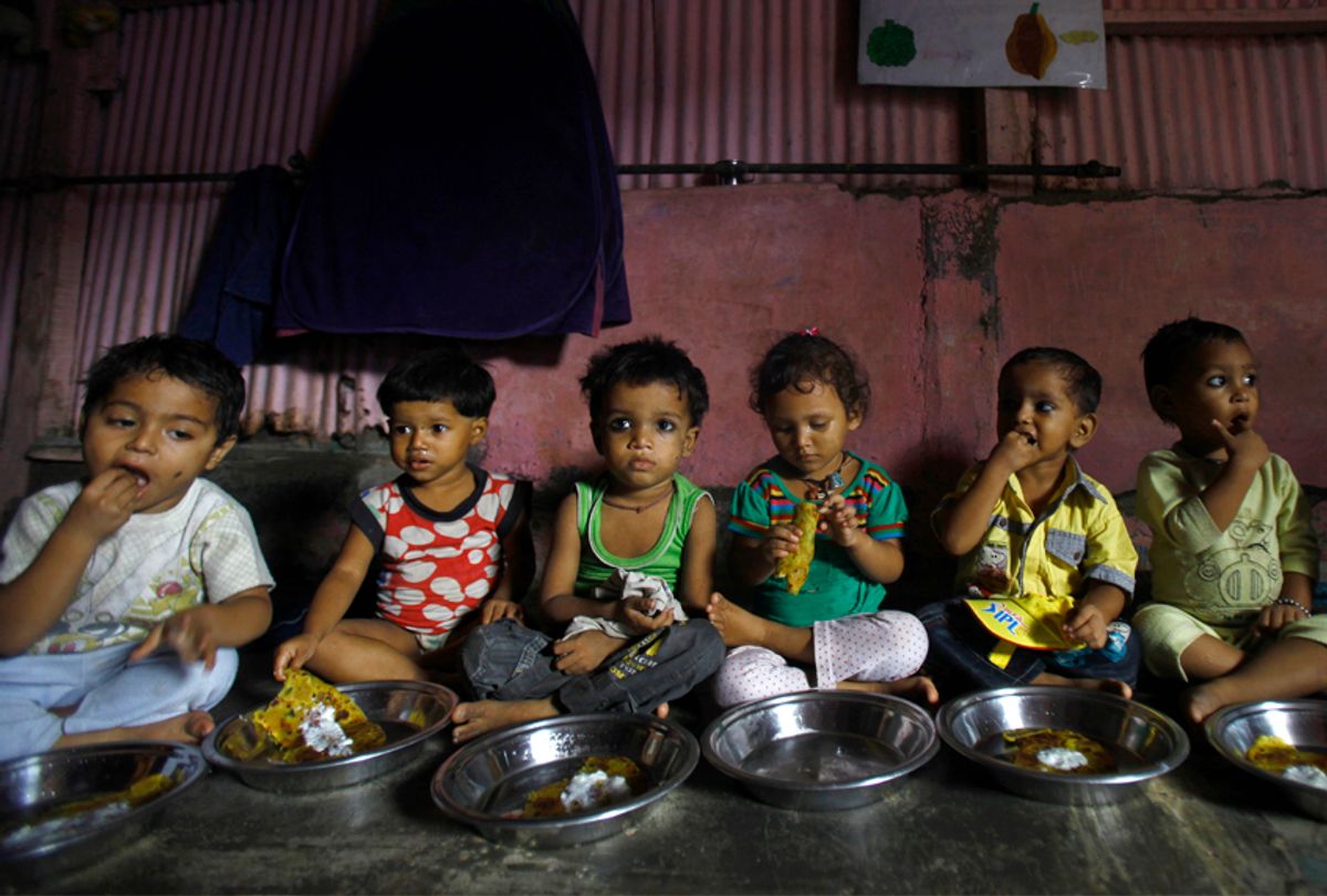 Malnourished children eat a meal at the Apanalaya Center in Mumbai, India, Oct. 9, 2012. (AP/Rafiq Maqbool)