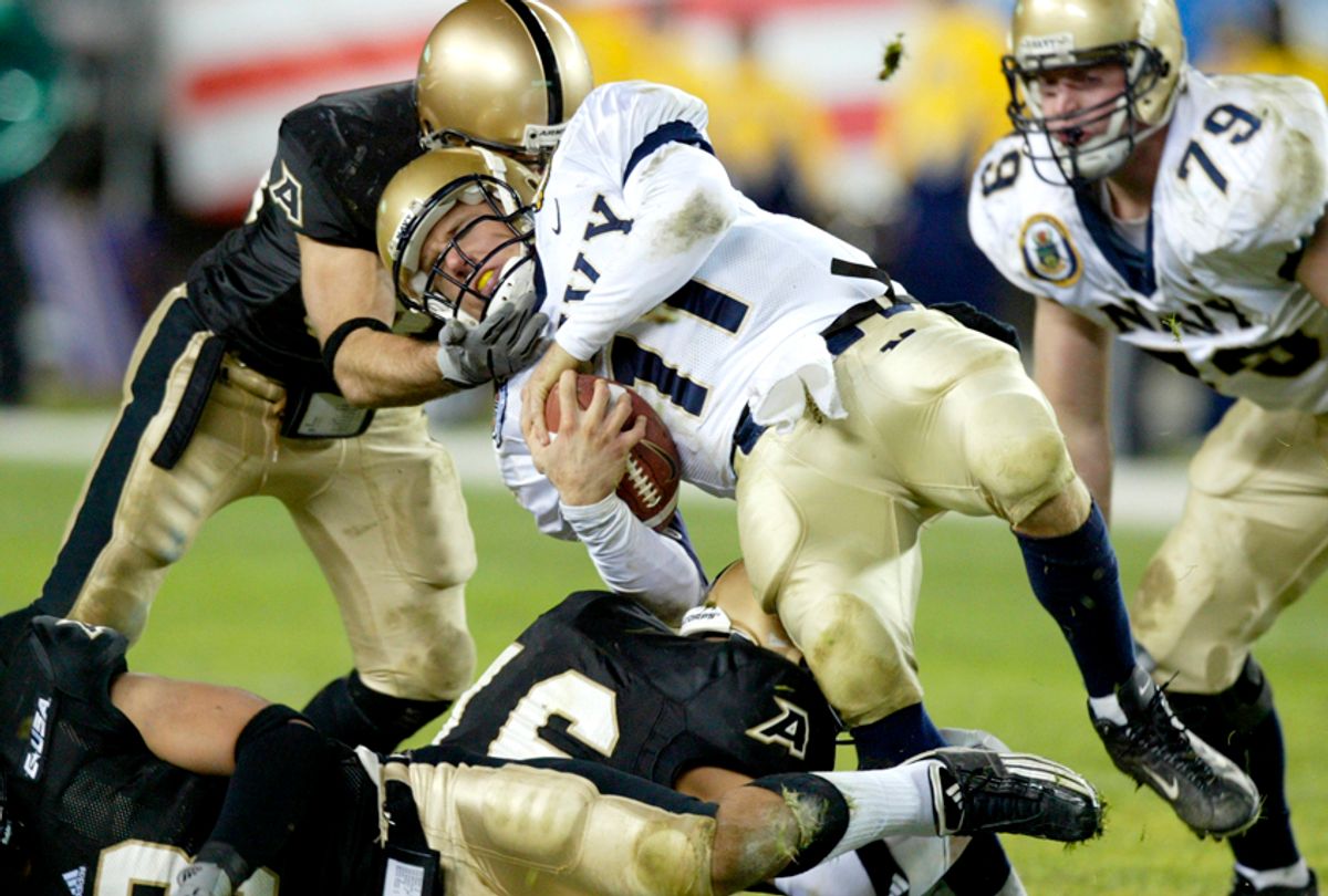 An unidentified Army defender pulls down Navy quarterback Craig Candeto (11)  in the third quarter the 104th Army-Navy football game, Dec. 6, 2003.  (AP/Rusty Kennedy)