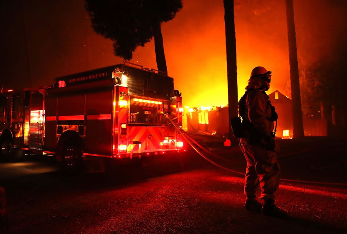 Firefighters try to save a building as the Camp Fire moves through the area on November 8, 2018 in Paradise, California (Getty/Justin Sullivan)
