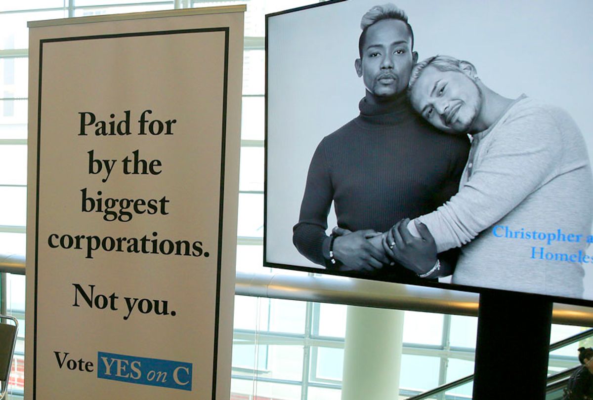 Signs urge support for Proposition C at a SPUR luncheon in San Francisco. (AP/Eric Risberg)
