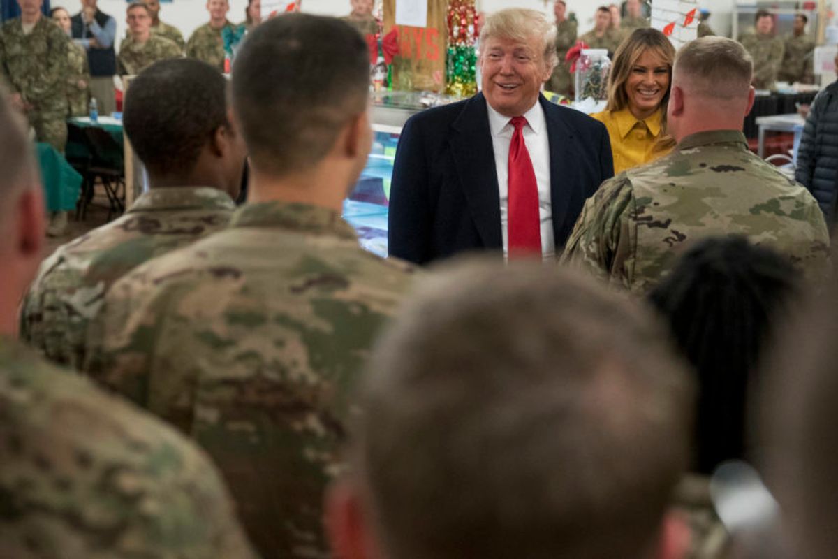 President Donald Trump and first lady Melania Trump visit with members of the military at a dining hall at Al Asad Air Base, Iraq, Wednesday, Dec. 26, 2018. (AP Photo/Andrew Harnik) (AP)