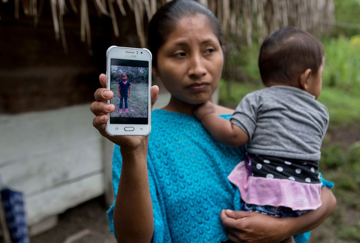 Claudia Maquin, 27, shows a photo of her daughter, Jakelin Amei Rosmery Caal Maquin in Raxruha, Guatemala, on Saturday, Dec. 15, 2018. (AP/Oliver de Ros)