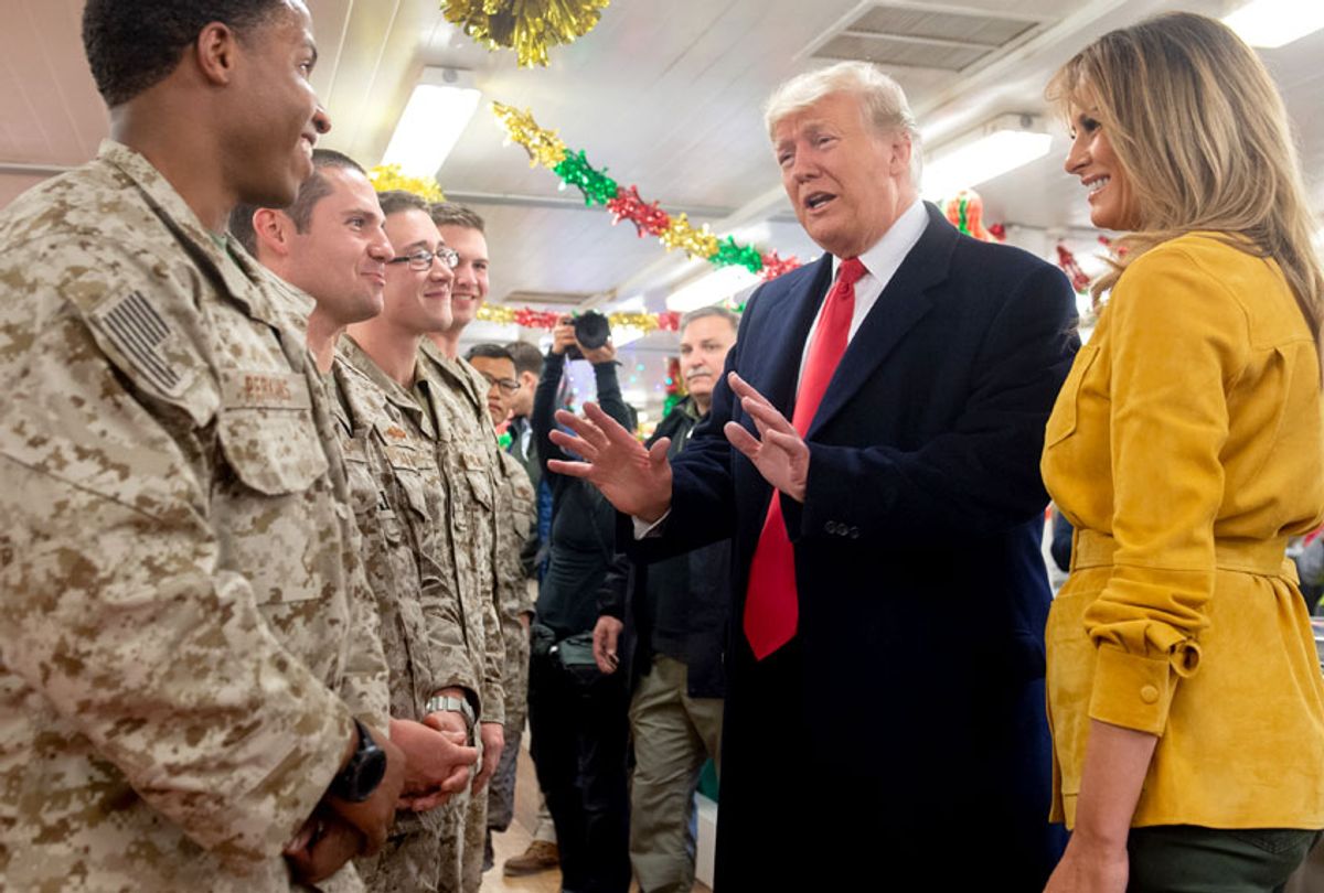 US President Donald Trump and First Lady Melania Trump greet members of the US military during an unannounced trip to Al Asad Air Base in Iraq on December 26, 2018. (Getty/Saul Loeb)