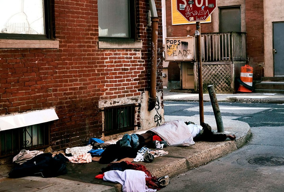 A homeless man sleeps on a sidewalk on October 18, 2018 in Philadelphia, Pennsylvania. (Getty/Spencer Platt)