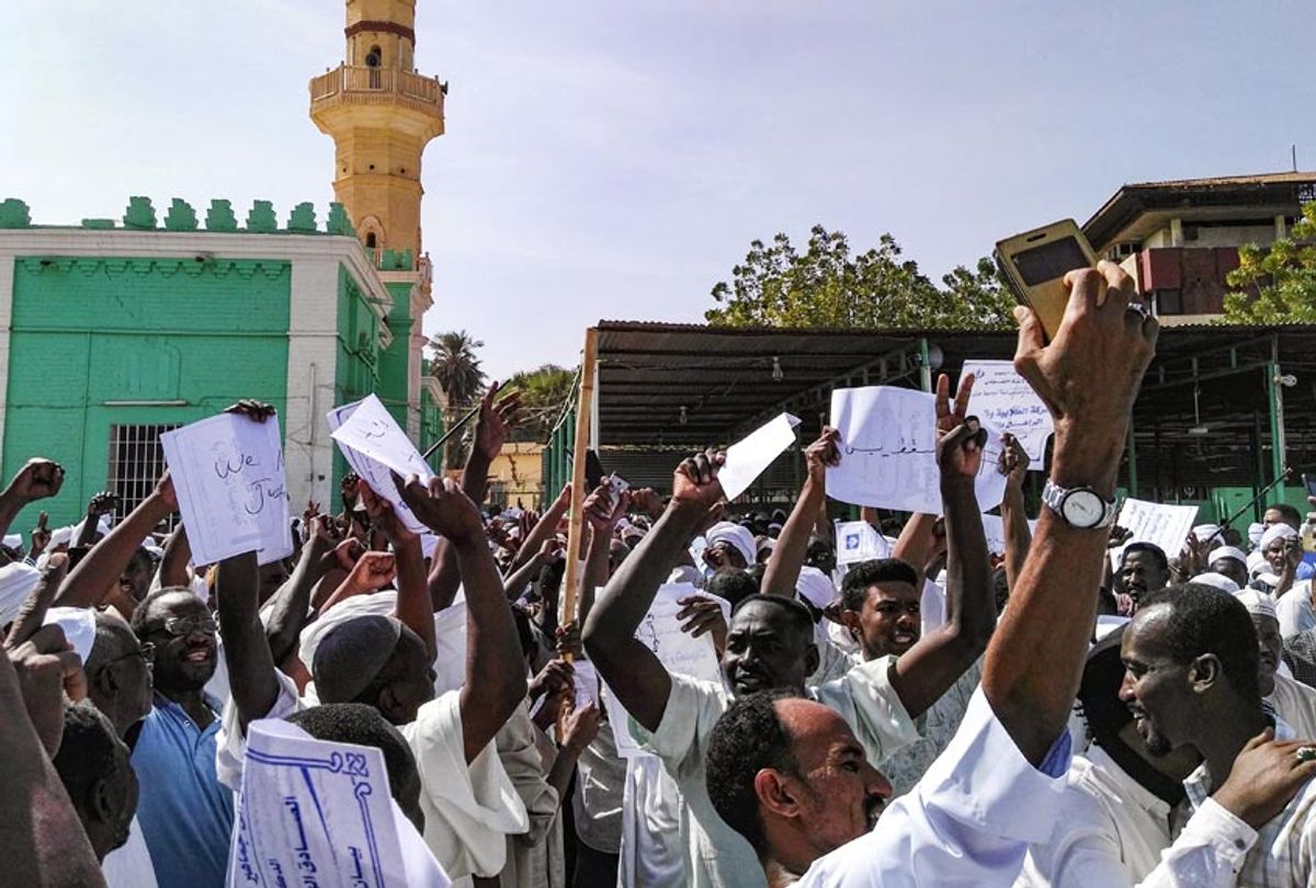 Sudanese protesters chant slogans and raise signs against President Omar al-Bashir during a demonstration in the capital Khartoum's twin city of Omdurman on January 25, 2019. (-/AFP/Getty Images)