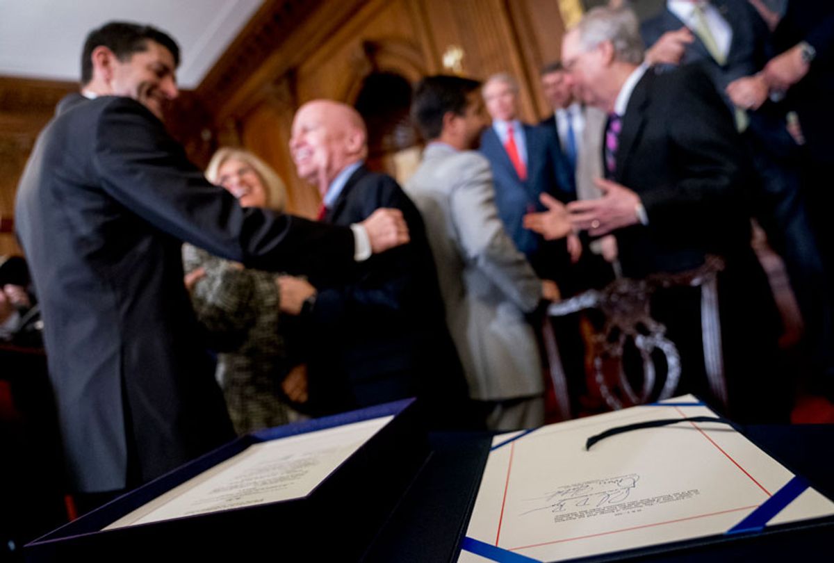 The signatures of Paul Ryan and Orrin Hatch can be seen as Ryan and Kevin Brady congratulate each other after signing the final version of the GOP tax bill during an enrollment ceremony at the Capitol in Washington, Dec. 21, 2017. (AP/Andrew Harnik)