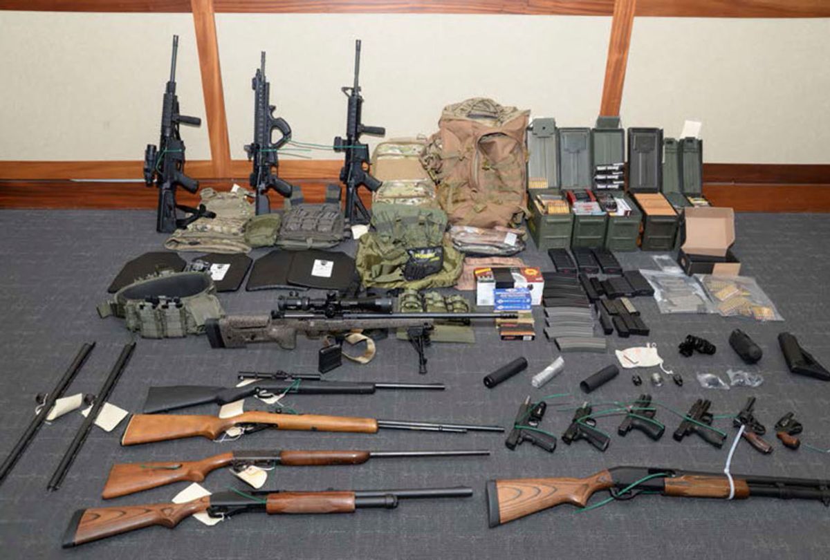 This image provided by the U.S. District Court in Maryland shows a photo of firearms and ammunition that was in the motion for detention pending trial in the case against Christopher Paul Hasson. (U.S. District Court via AP)