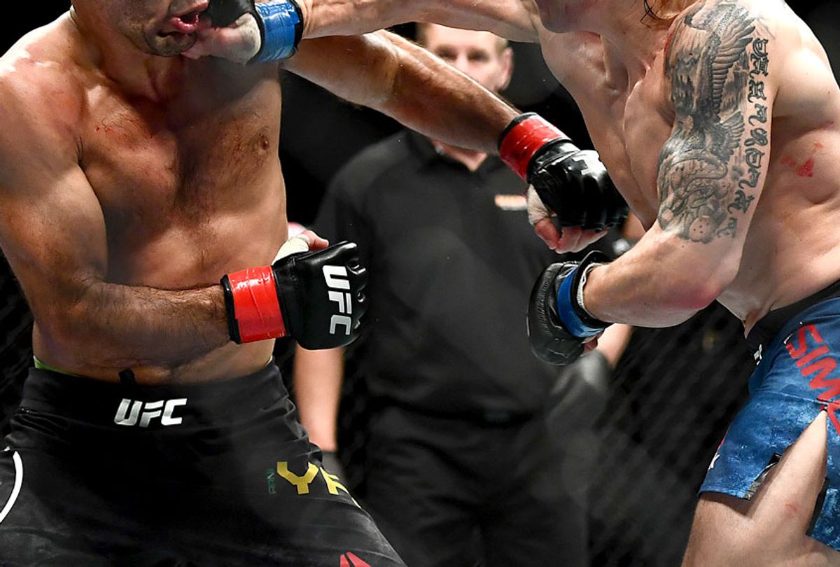 Ricky Simon punches Rani Yahya during their Bantamweight bout during UFC234 on February 10, 2019 in Melbourne, Australia. (Getty/Quinn Rooney)