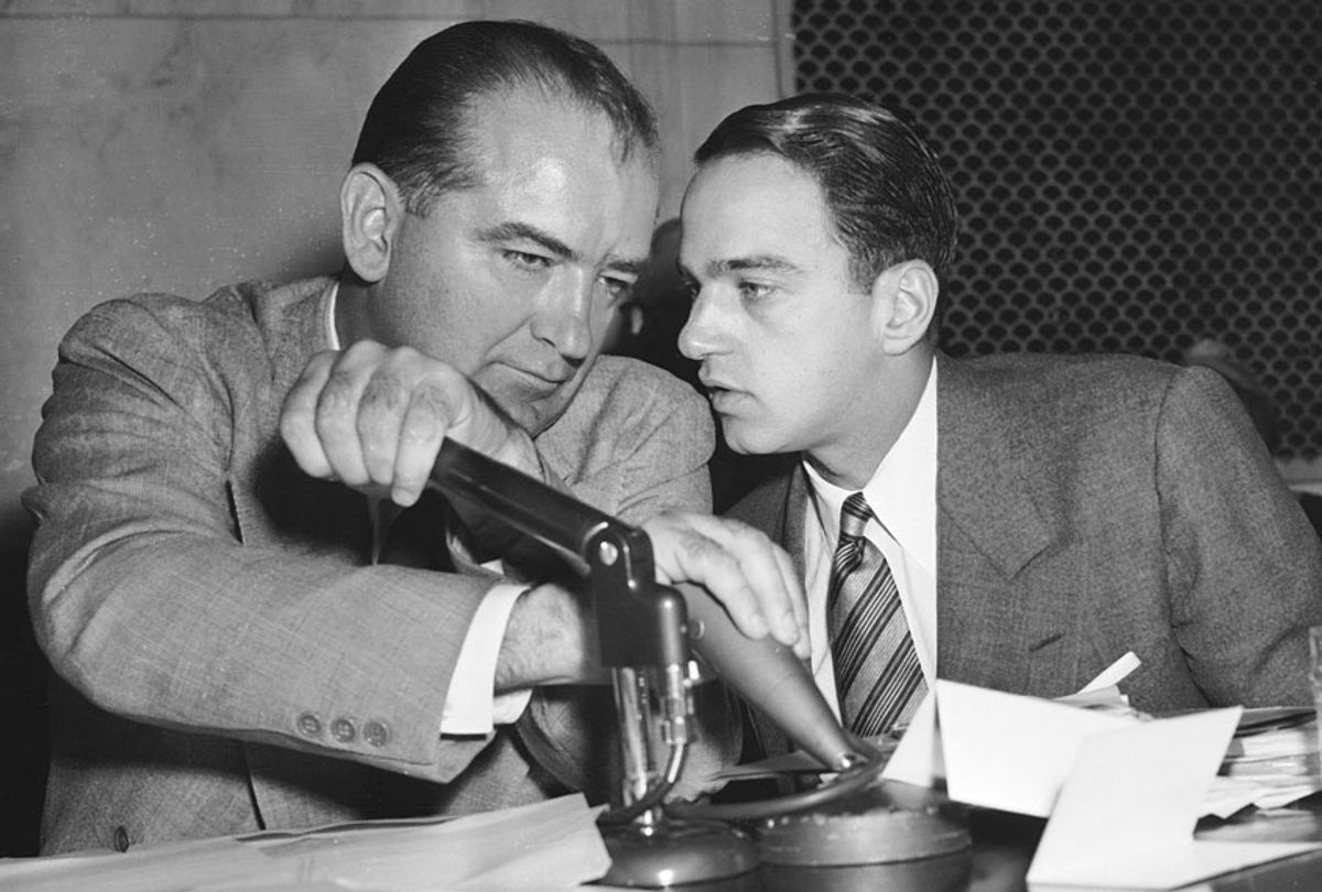 Senator Joseph McCarthy has a whispered discussion with Roy Cohn during a committee hearing on April 26, 1954, in Washington. (AP Photo)