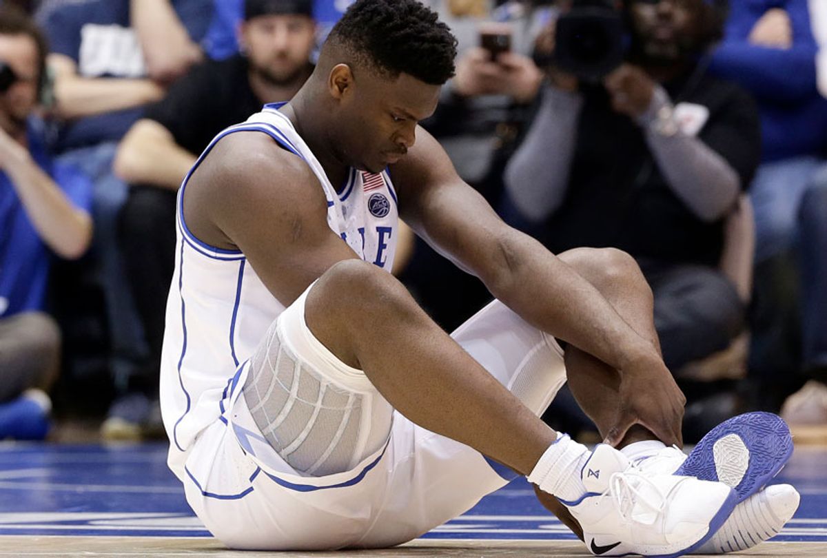 Duke's Zion Williamson sits on the floor following a injury during the first half of an NCAA college basketball game against North Carolina in Durham, N.C., Wednesday, Feb. 20, 2019. (AP/Gerry Broome)
