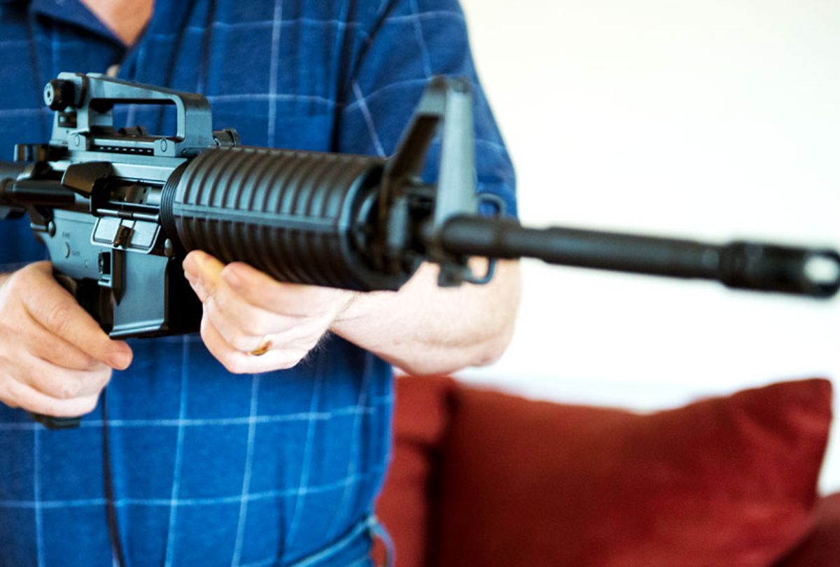 A man holding a Colt AR-15 semi-automatic rifle. (Getty/Karen Bleier)
