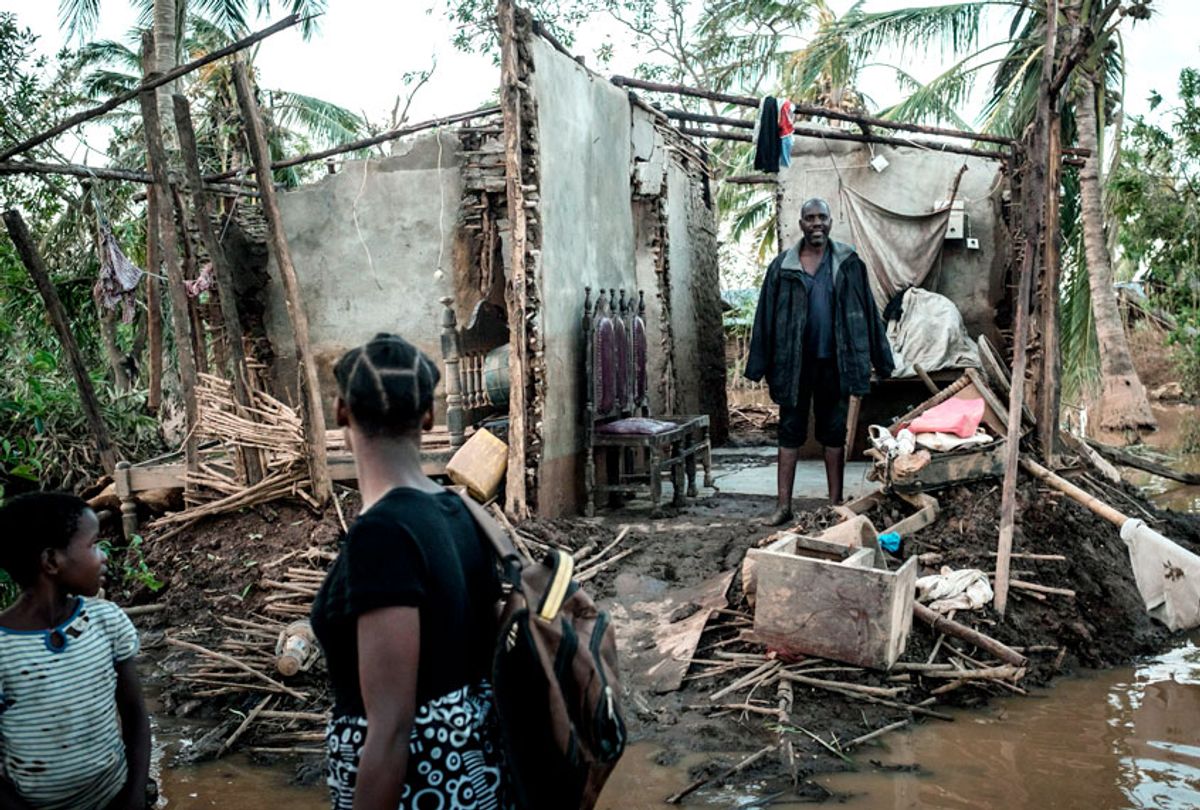 Joaninha Manuel, 9, and her sister Rosita Moises Zacarias, 15, look at their father Francisco Simon in their house destroyed by the cyclone Idai as they go to seep in a shelter in Buzi, Mozambique, on March 22, 2019. (Getty/Yasuyoshi Chiba)