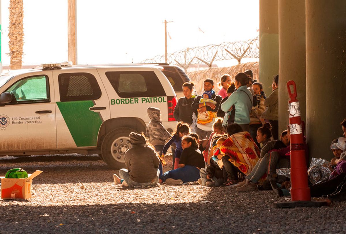 Migrants held in temporary fencing underneath the Paso Del Norte Bridge await processing on March 28, 2019 in El Paso, Texas. (Getty/Christ Chavez)